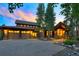 Inviting front exterior showcasing a three-car garage and charming architectural details at sunset at 805 Highfield Trl, Breckenridge, CO 80424