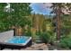 Relax in this outdoor hot tub with stunning mountain views and lush landscaping, perfect for unwinding after a long day at 805 Highfield Trl, Breckenridge, CO 80424