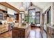 Gourmet kitchen features a spacious island, stainless steel appliances, and views of the surrounding mountains at 805 Highfield Trl, Breckenridge, CO 80424