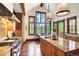 Bright kitchen boasts an island with granite countertops, stainless appliances and scenic outdoor views from large windows at 805 Highfield Trl, Breckenridge, CO 80424