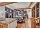 Open-concept living room features a dining area, stone fireplace, and large windows with views of the outdoors at 805 Highfield Trl, Breckenridge, CO 80424