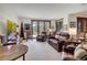 Comfortable living room with leather furniture, scenic views, and an adjacent outdoor area at 805 Highfield Trl, Breckenridge, CO 80424