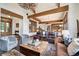 Comfortable living area boasts wood beams, stone fireplace, with an open design that flows into the dining area at 805 Highfield Trl, Breckenridge, CO 80424