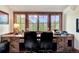 Office space with a custom wood desk, mountain views, and large windows providing plenty of natural light at 805 Highfield Trl, Breckenridge, CO 80424