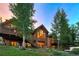 A scenic backyard featuring a large deck, hot tub, and beautiful architectural woodwork at 805 Highfield Trl, Breckenridge, CO 80424