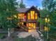 Charming exterior with a second story deck, stairs, stone details, and landscaped yard at 805 Highfield Trl, Breckenridge, CO 80424