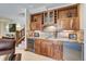 Elegant wet bar featuring wood cabinetry, granite countertops, and a wine refrigerator at 805 Highfield Trl, Breckenridge, CO 80424