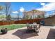 The backyard has a stone patio with an umbrella-covered dining table and chairs at 7960 Estes Ct, Arvada, CO 80005