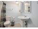 Standard bathroom with shower and tub combination, toilet, and pedestal sink at 7960 Estes Ct, Arvada, CO 80005