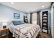 Relaxing bedroom with bright blue walls, patterned bedding, and a leaning ladder bookcase at 7960 Estes Ct, Arvada, CO 80005