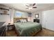 Cozy bedroom featuring a wood-frame bed, stylish shelves, and a ceiling fan for added comfort at 7960 Estes Ct, Arvada, CO 80005