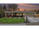 Charming ranch-style home with well-manicured lawn, brick accents, and a cozy, inviting entrance under a colorful sky at 7960 Estes Ct, Arvada, CO 80005