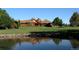 Beautiful clubhouse overlooking a pond and golf course, with lush greenery and blue skies at 7960 Estes Ct, Arvada, CO 80005