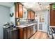 Beautiful kitchen equipped with stainless steel appliances, warm wood cabinetry, and granite countertops, creating a functional cooking space at 7960 Estes Ct, Arvada, CO 80005
