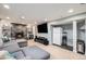 Finished basement with cozy living room setup featuring a fireplace and a full-sized refrigerator at 7960 Estes Ct, Arvada, CO 80005