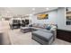 Finished basement with large sectional couch and bonus area with a dark wood table at 7960 Estes Ct, Arvada, CO 80005