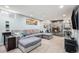 Spacious living room with a large sectional couch, stone fireplace, and recessed lighting at 7960 Estes Ct, Arvada, CO 80005