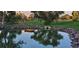Scenic view of a pond reflecting the sky with a canoe decorated with flowers in the water at 7960 Estes Ct, Arvada, CO 80005