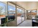 Enclosed sunroom features sliding glass doors leading to a patio and a backyard with a grill at 7960 Estes Ct, Arvada, CO 80005