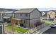 Backyard of a gray two-story home with pergola and a white wooden fence at 2688 Loon Cir, Castle Rock, CO 80104