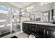Bathroom featuring a shower and a double sink vanity with granite countertops at 2688 Loon Cir, Castle Rock, CO 80104