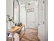 Bright entryway features a wooden console table, a decorative mirror, and a door to the hallway at 2688 Loon Cir, Castle Rock, CO 80104