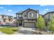 Charming two-story home with a manicured lawn, a two-car garage, and stylish gray siding at 2688 Loon Cir, Castle Rock, CO 80104