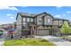 Inviting two-story home with a manicured lawn, a two-car garage, and modern solar panels at 2688 Loon Cir, Castle Rock, CO 80104