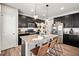 Kitchen features dark cabinets, granite countertops, stainless steel appliances and an island with seating at 2688 Loon Cir, Castle Rock, CO 80104