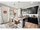 Modern kitchen features dark cabinets, granite countertops, an island with seating, and stainless appliances at 2688 Loon Cir, Castle Rock, CO 80104