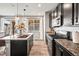Kitchen features dark cabinets, granite countertops, a kitchen island, and stainless steel appliances at 2688 Loon Cir, Castle Rock, CO 80104