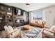 Modern living room with a fireplace, large TV, display cabinets and lots of natural light at 2688 Loon Cir, Castle Rock, CO 80104