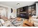Cozy living room with a fireplace, display cabinets and a comfortable seating area at 2688 Loon Cir, Castle Rock, CO 80104