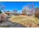 Expansive backyard featuring a well-maintained lawn, patio area, mature trees, and a charming pergola at 3680 S Glencoe St, Denver, CO 80237