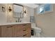 Bathroom vanity with quartz countertop, dark wood cabinets, modern fixtures, and updated lighting at 3680 S Glencoe St, Denver, CO 80237