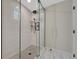 Modern bathroom shower with glass enclosure, herringbone tile floor and sleek fixtures at 3680 S Glencoe St, Denver, CO 80237