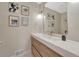 Stylish bathroom with a modern vanity, decorative mirror, and unique wall art at 3680 S Glencoe St, Denver, CO 80237