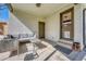 A covered outdoor patio features a seating area with a gray sofa and table, next to two doors at 3680 S Glencoe St, Denver, CO 80237