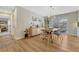 Elegant dining room with hardwood floors, a modern chandelier, and access to an outdoor patio at 3680 S Glencoe St, Denver, CO 80237