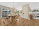 Open dining area featuring a modern light fixture, wood table, and sliding doors to an outdoor area at 3680 S Glencoe St, Denver, CO 80237