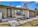 Close-up of home showcasing a modern front door, stylish landscaping, and an attached garage at 3680 S Glencoe St, Denver, CO 80237