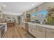 Bright kitchen with a large window, stainless steel appliances, and herringbone backsplash at 3680 S Glencoe St, Denver, CO 80237