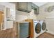 Convenient laundry room with modern appliances, custom cabinetry, and butcher block countertops at 3680 S Glencoe St, Denver, CO 80237