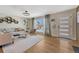 Stylish living room with hardwood floors, modern decor, and ample natural light streaming through a large window at 3680 S Glencoe St, Denver, CO 80237