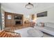 Cozy living room featuring hardwood floors, a modern fireplace, and comfortable seating at 3680 S Glencoe St, Denver, CO 80237