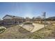 Backyard featuring a basketball hoop, trampoline, brick house, and picnic table at 7217 Huron St, Denver, CO 80221