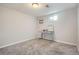 Bedroom featuring carpet, a light, and desk with shelves under a window at 7217 Huron St, Denver, CO 80221