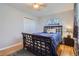 Bedroom featuring hardwood floors, a ceiling fan, stained glass window and a bed with blue comforter at 7217 Huron St, Denver, CO 80221