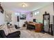 Basement office featuring carpeted floors, couch, a desk, and entertainment center with television at 7217 Huron St, Denver, CO 80221