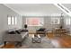 Bright living room features hardwood floors, modern gray furnishings, and contemporary decor at 1242 Gaylord St # 101, Denver, CO 80206